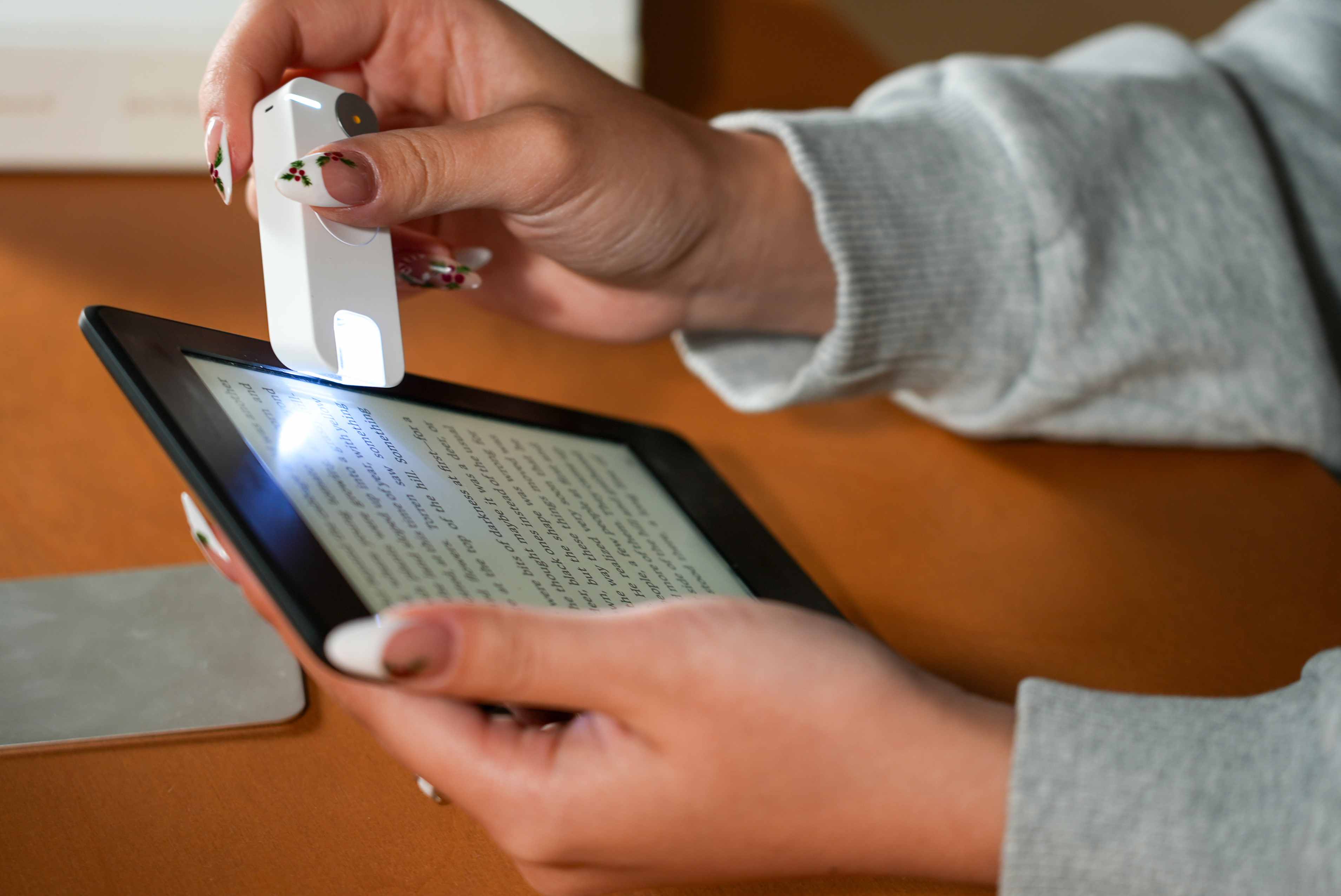 Mark device scanning text on a Kindle e-reader screen with scanner light visible