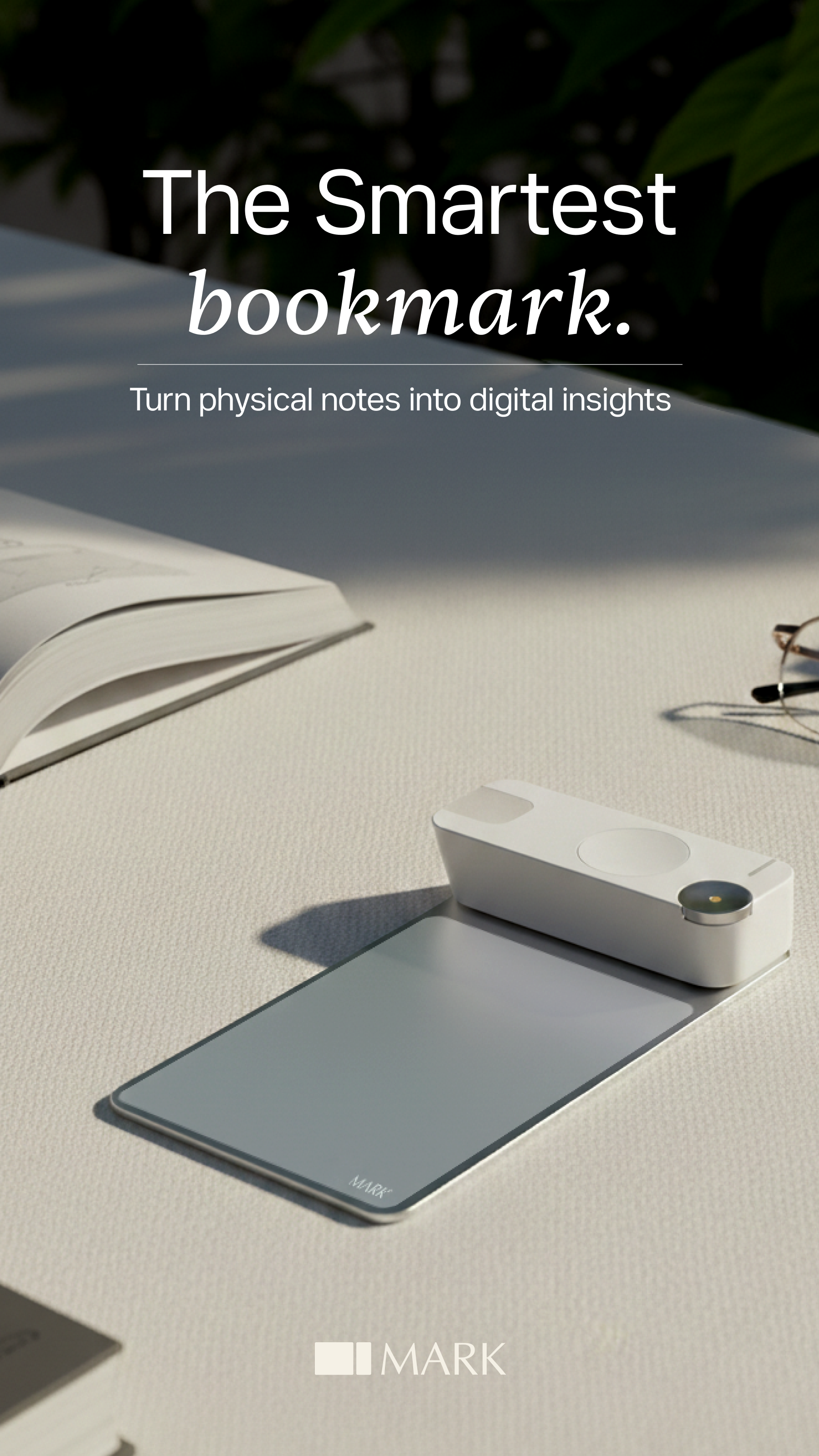 Mark device resting on a desk beside an open book